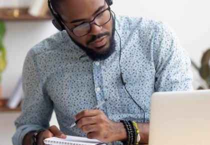 Man studying on laptop for online MBA program
