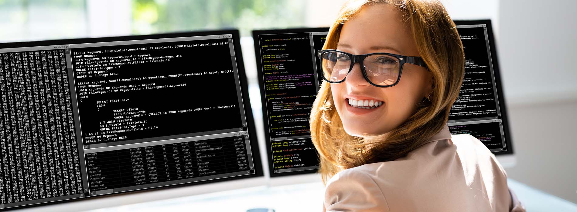 woman programmer at two computer screens with code