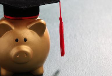 Piggy bank wearing a graduation cap