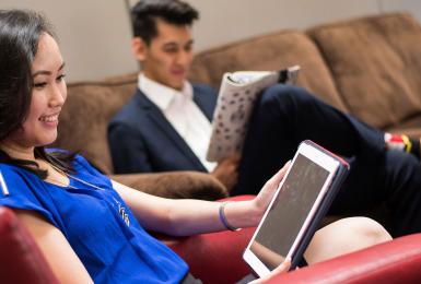 Students in lounge area working on computers