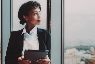 Female business leader looking out window