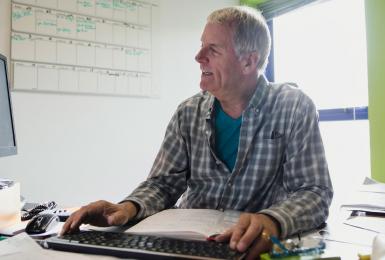 Man working at a computer in a home office 