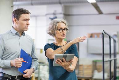 Two professionals examining a warehouse