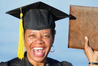 Proud graduate holding diploma