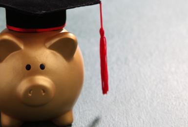 Piggy bank wearing a graduation cap