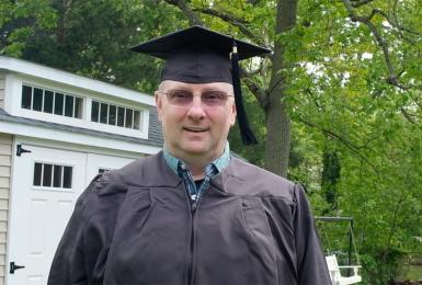 2020 Champlain Graduate in cap and gown