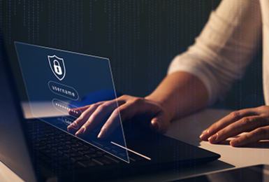 Woman's hands at a laptop typing in a password