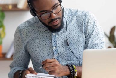 Man studying on laptop for online MBA program
