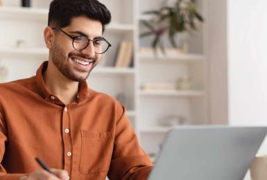 Man at laptop working on a class assignment