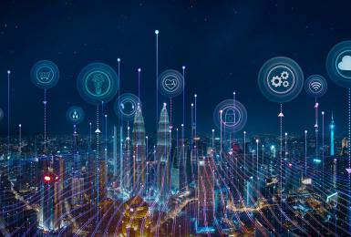 Night skyline with smart devices and icons representing Internet of Things concept.