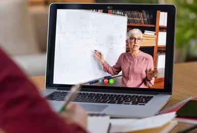 Adult woman attending online class on a laptop 
