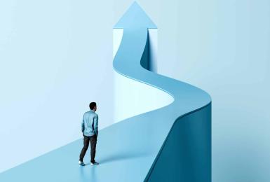 Man walking on light blue curved path shaped like an arrow