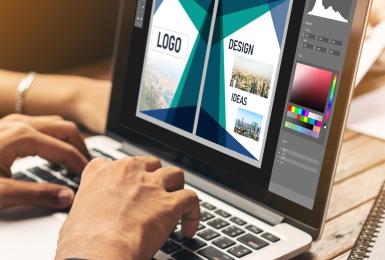 Digital media professional working on portfolio on a laptop