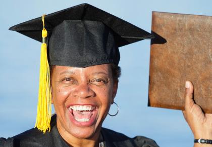Proud graduate holding diploma
