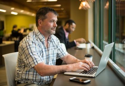 Male student working on laptop