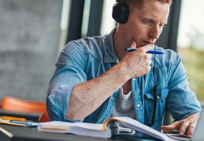 Student on laptop wearing headphones 