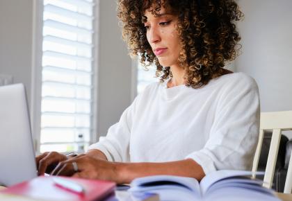 Woman studying and working on her laptop.