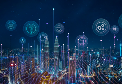 Night skyline with smart devices and icons representing Internet of Things concept
