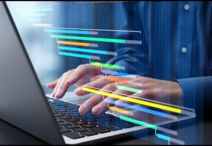 Person typing on a laptop with a colorful Gantt chart project timeline overlay