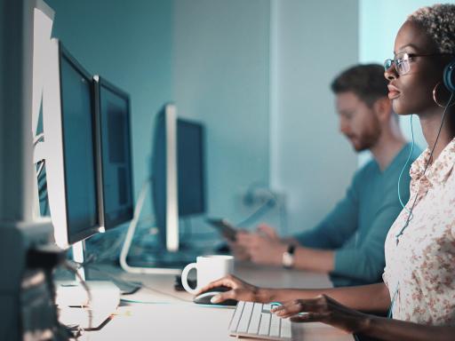 Woman in a computer lab looking at computer