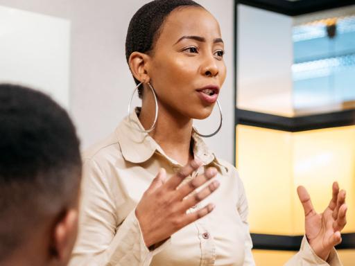 Business woman presenting to colleagues in office