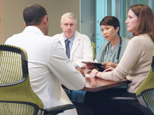 Group of healthcare professionals meeting around a table