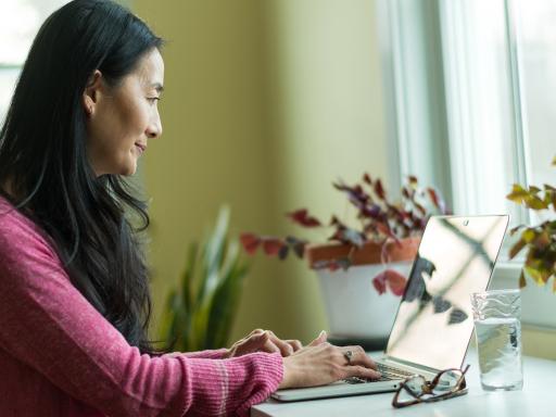 Korean woman at laptop at home