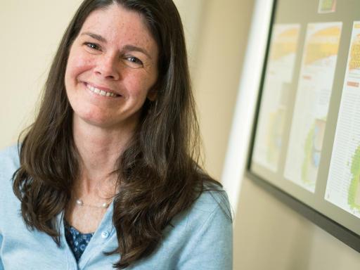 Adult female student in office setting smiling at camera