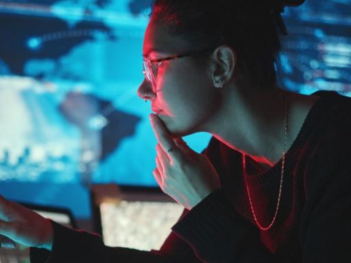 woman looking at a computer screen with digital forensic information on it