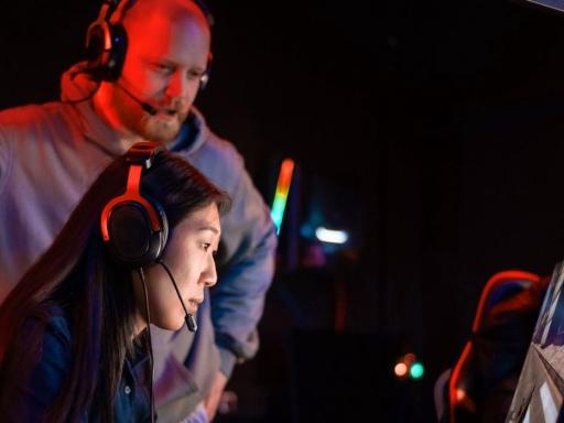 Esports coach working with asian american female gamer