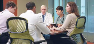 Group of healthcare professionals meeting around a table