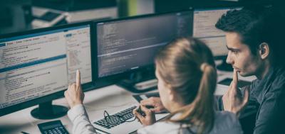 Professionals looking at forensics data on a monitor 