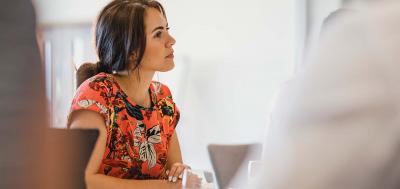 Female leader in the workplace listening to colleague 