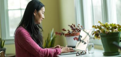 Korean woman at laptop at home