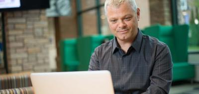 Adult Male Cybersecurity Student working on laptop