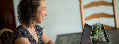 Female students looking at laptop smiling