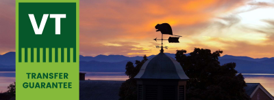 VT Transfer guarantee logo overlay image of Champlian College rooftops overlooking lake at sunset