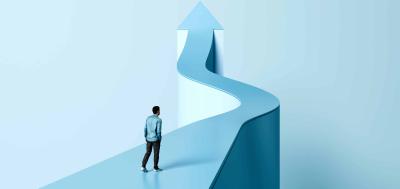 Man walking on light blue curved path shaped like an arrow