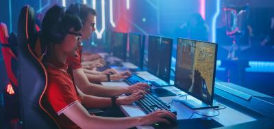 Several professional PC gamers sitting at a table playing online games 