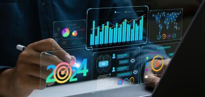 Businessman works on laptop Showing 2024 business trends dashboard with charts, metrics, AI, E-commerce, KPI.