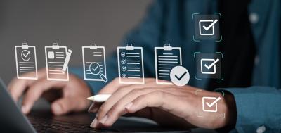 Businessman using laptop with pop-up digital icons of documents