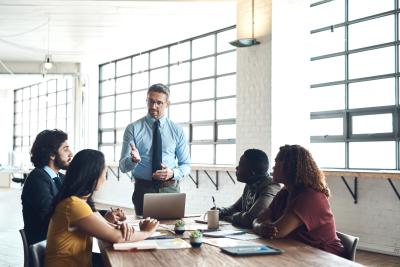 business leader speaking to group of professionals