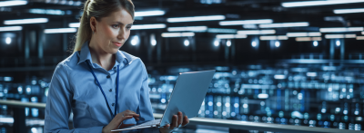 cybersecurity professional on laptop in server room