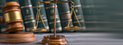 Law and Justice Symbols with law books on background