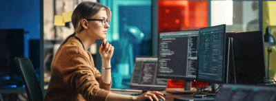  Junior Software Engineer Writes Code on Desktop Computer 