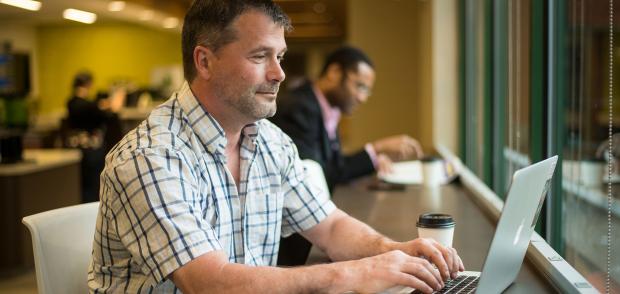 Male student working on laptop 
