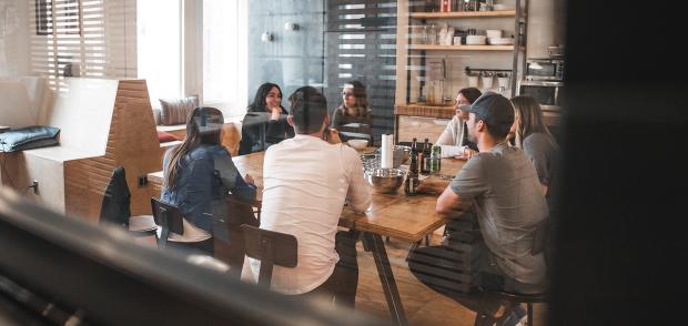 A dynamic team sits around a conference table