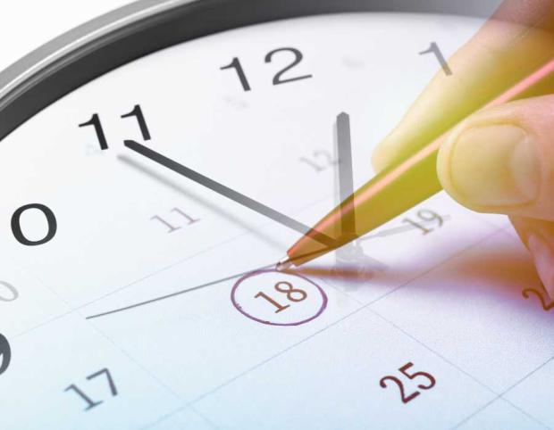 Clock with overlay of hand circling calendar date in pen