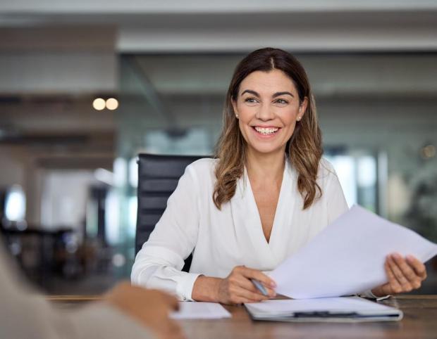 Smiling female project manager presenting crisis plan