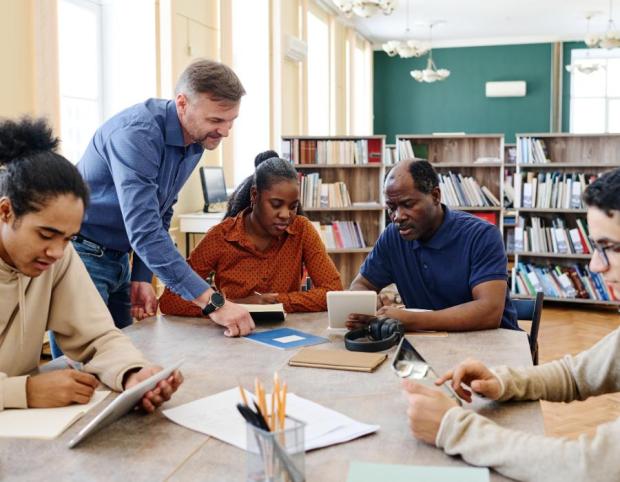 Adult group studying at a library table